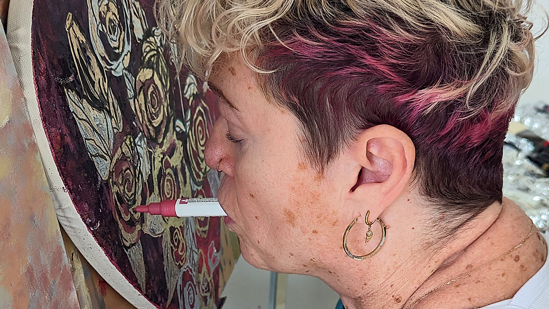 Alison Lapper painting with her mouth on a canvas.jpg
