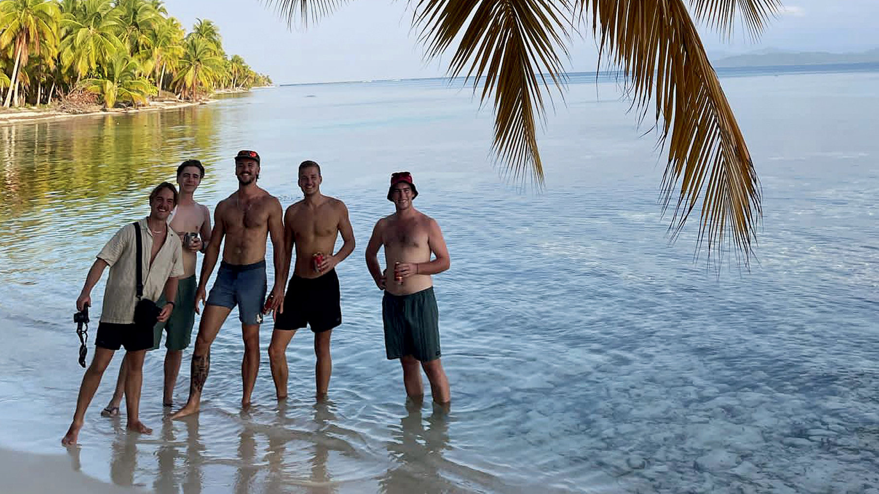 Luke Tarrant and some friends on the beach standing side-by-side.jpg