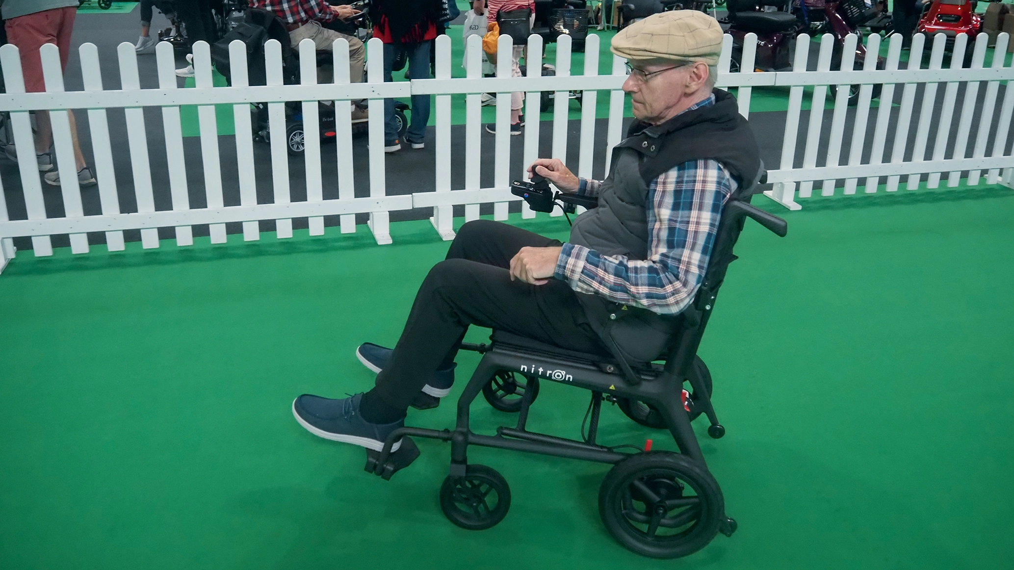 an-elderly-gentleman-piloting-a-carbon-fibre-wheelchair.webp