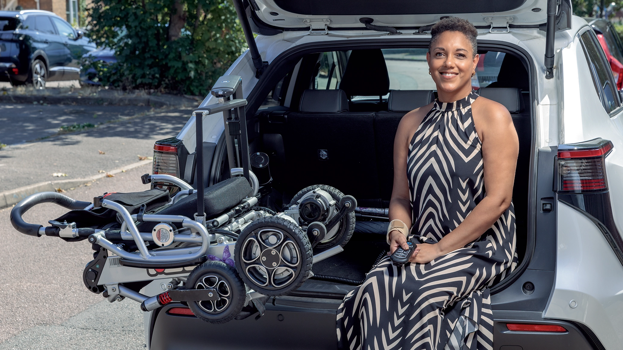 andie-by-her-motability-scheme-car-smiling-at-the-camera.webp