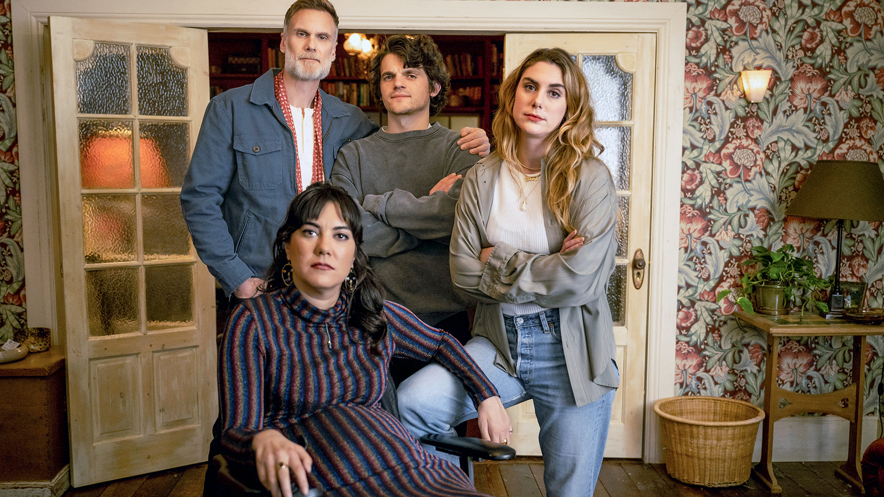 four-characters-from-the-sitcom-we-might-regret-this-stand-in-a-huddle-in-a-sitting-room-abe-darren-boyd-levi-edward-bluemel-jo-elena-saurel-and-wheelchair-user-freya-kyla-harris.jpg