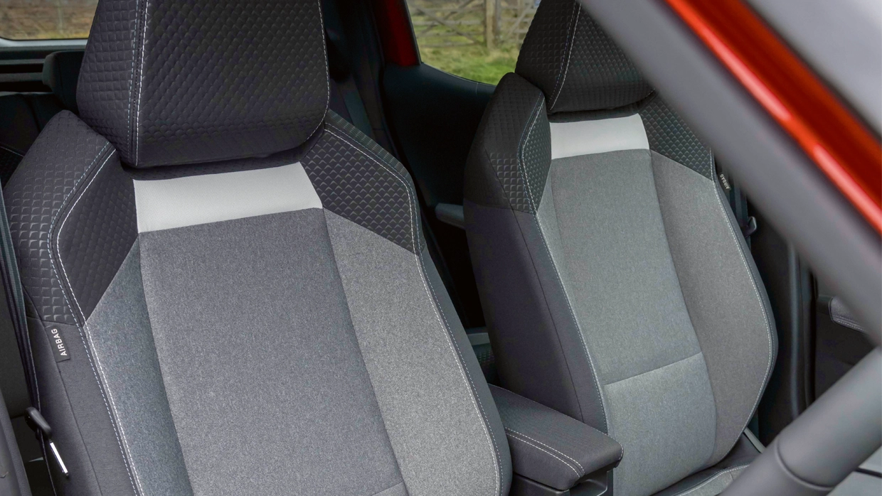 grey-two-tone-fabric-front-seats-of-a-vauxhall-frontera-electric-with-textured-detailing-and-side-airbag-tags.webp