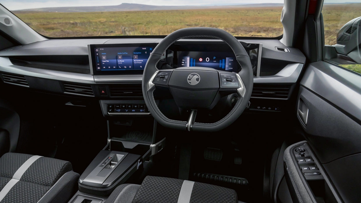 interior-view-of-a-vauxhall-frontera-electric-suv-featuring-a-digital-instrument-cluster-large-central-touchscreen-and-multi-function-steering-wheel.webp