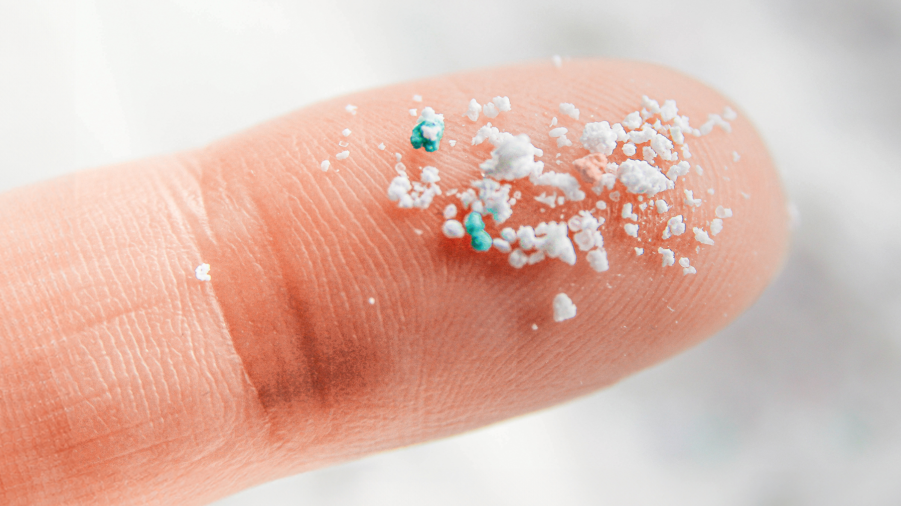 A finger with white reside on it