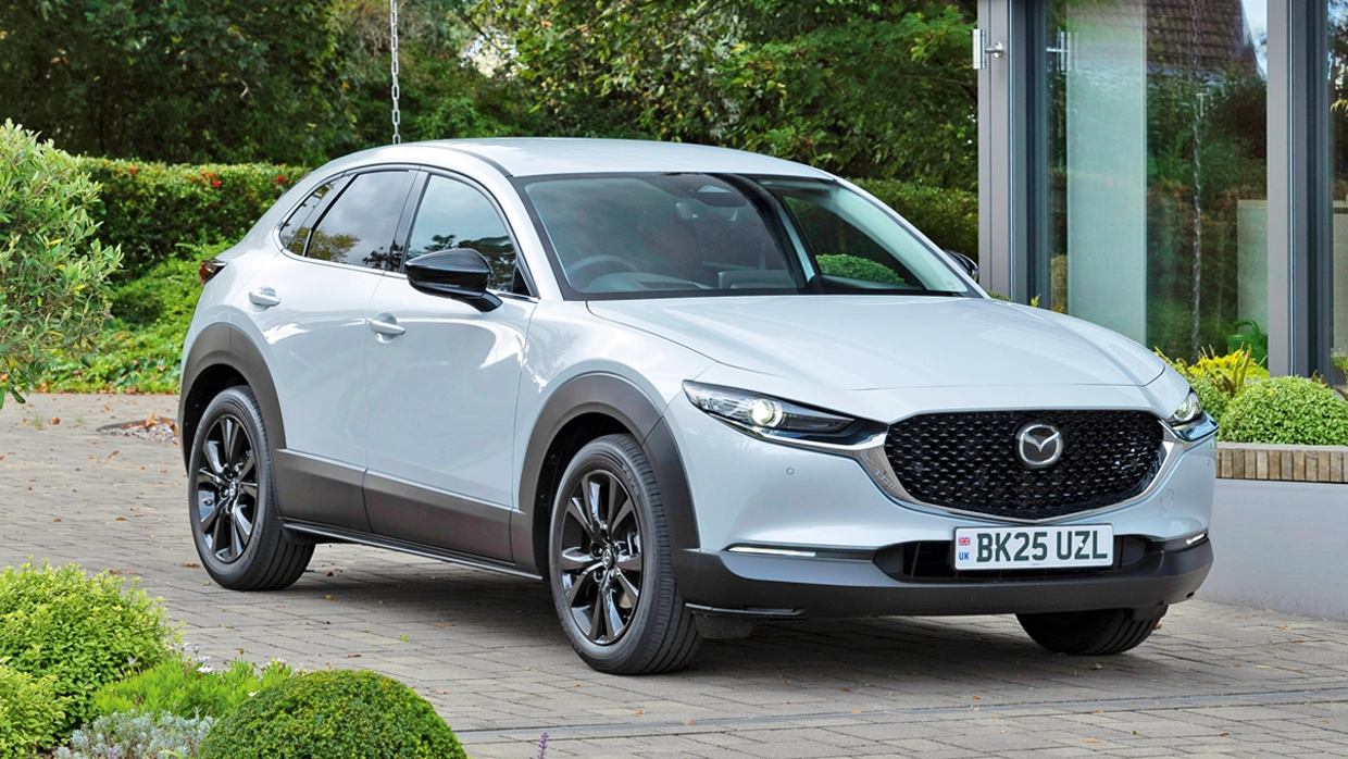 A light silver Mazda CX-30 (small-SUV) parked in a driveway