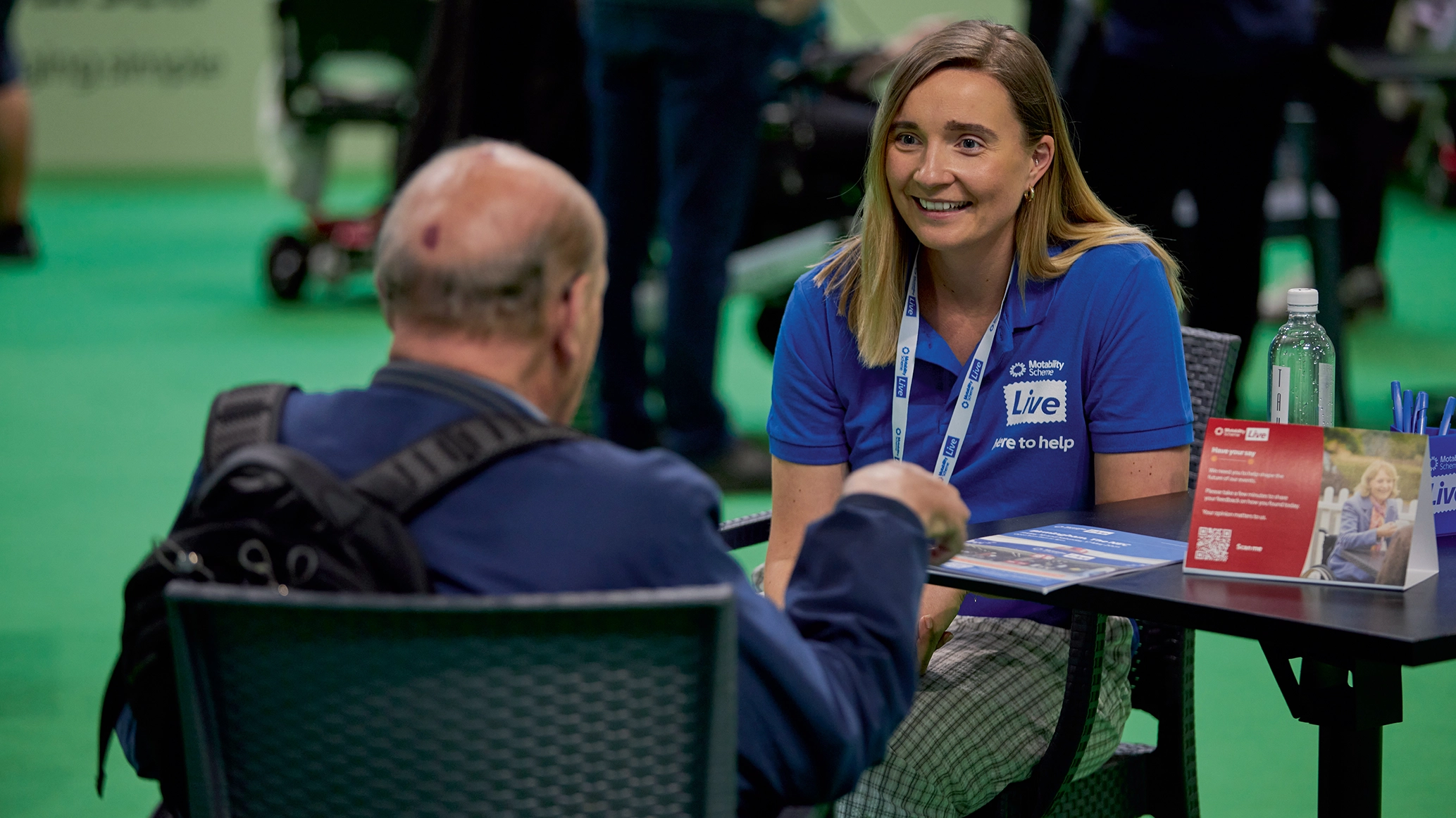 A Motability Scheme live staff member speaking to a visitor