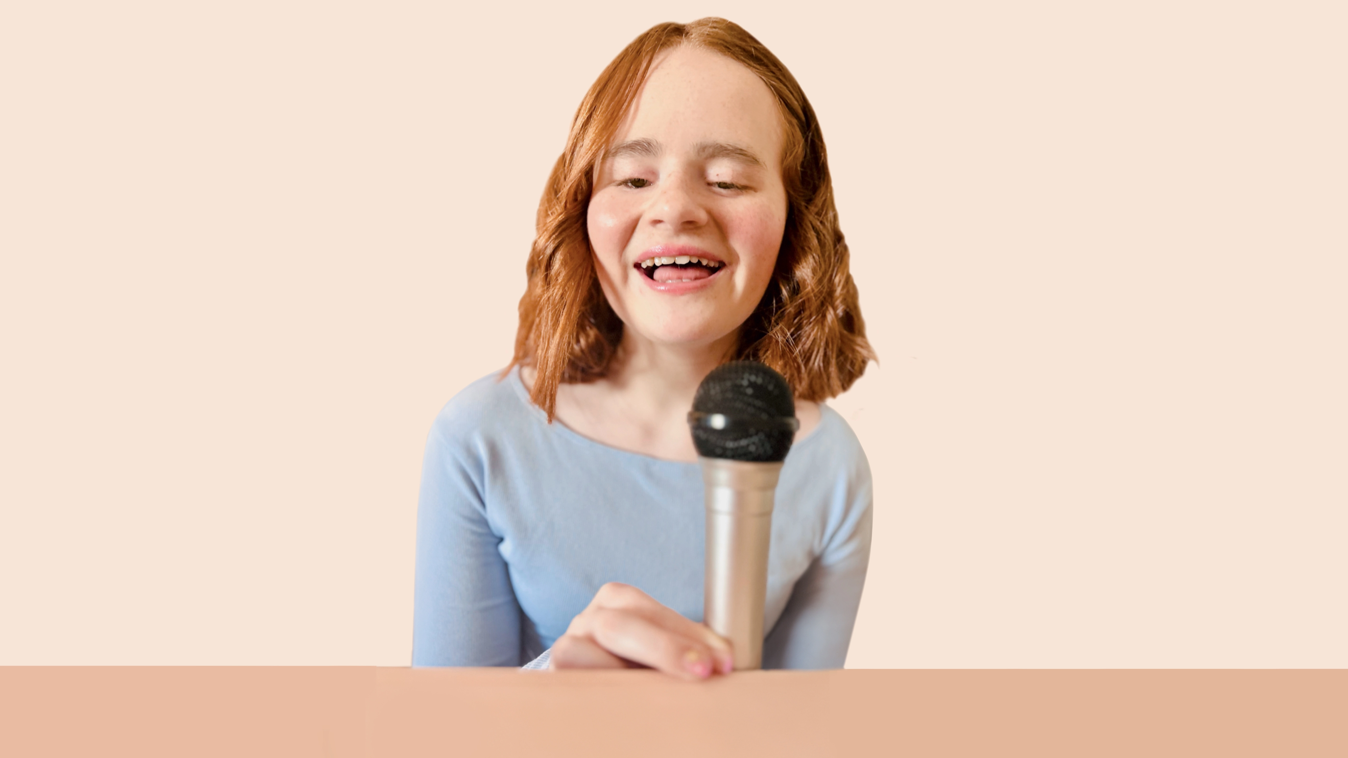 Photo of Evie with a mic smiling 