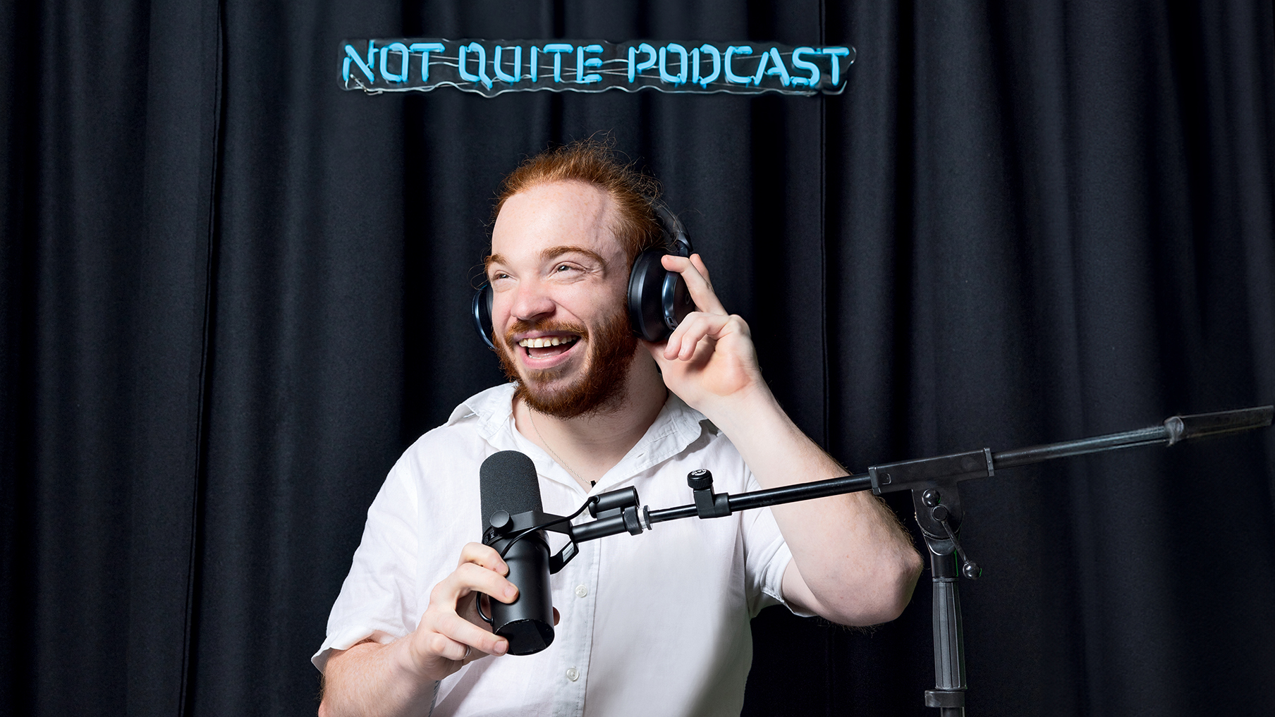 not-quite-podcast-host-charlie-randell-pictured-sat-with-headphones-on-in-front-of-a-mic-stand.jpg