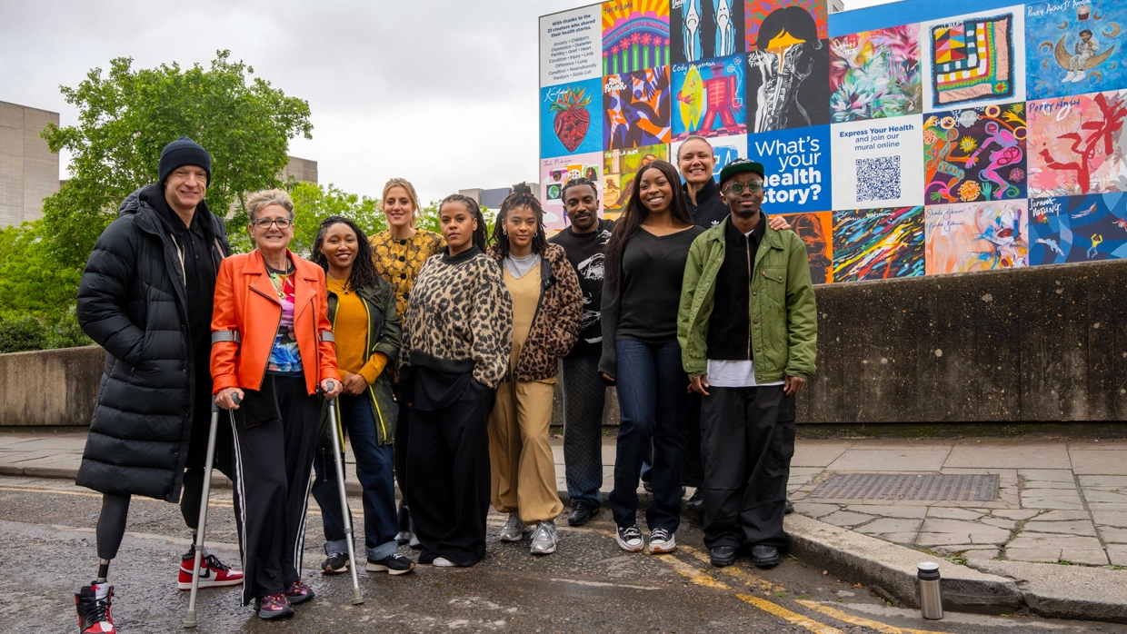 Bupa mural at Waterloo with artists.webp