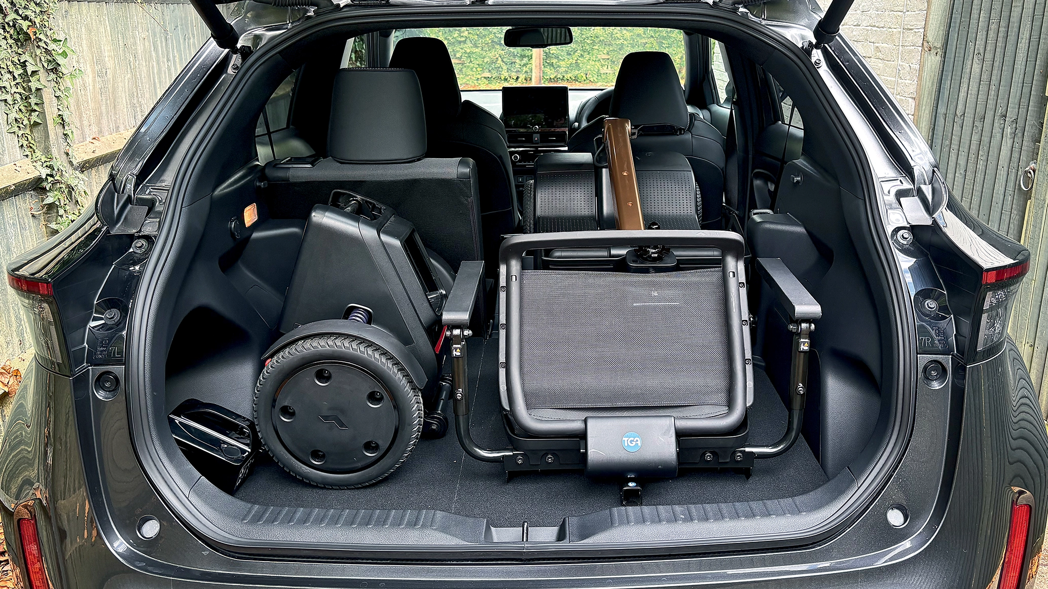 the-open-boot-of-a-toyota-yaris-cross-with-a-disassembled-mobility-scooter-inside.webp