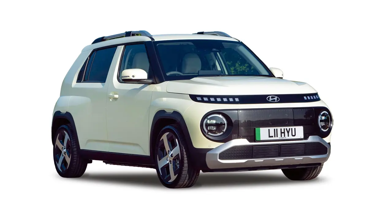 A white Hyundai Inster electric compact SUV with circular headlights and roof rails, isolated on a white background